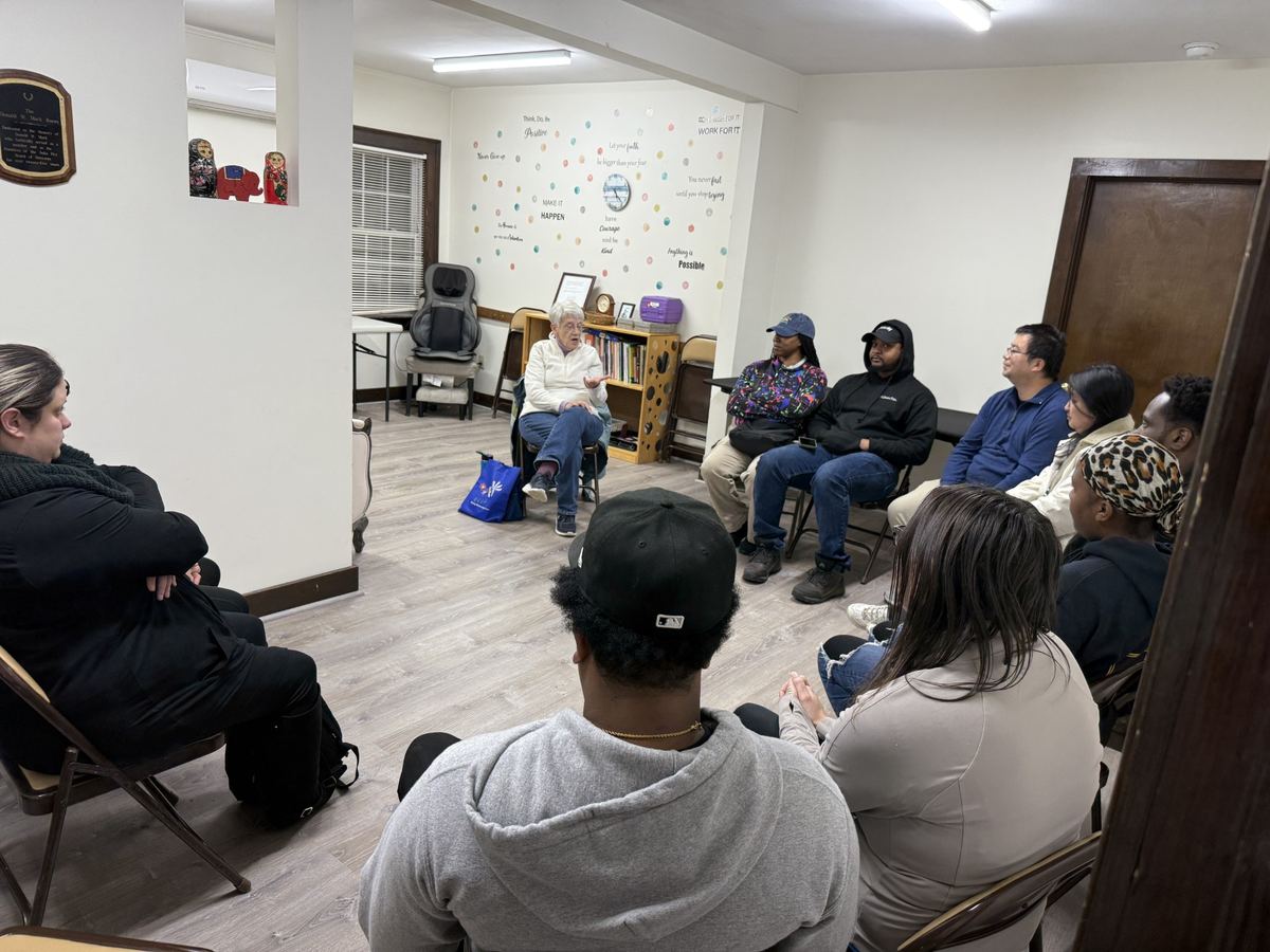 Parents seated in a circle in a classroom for a family training session