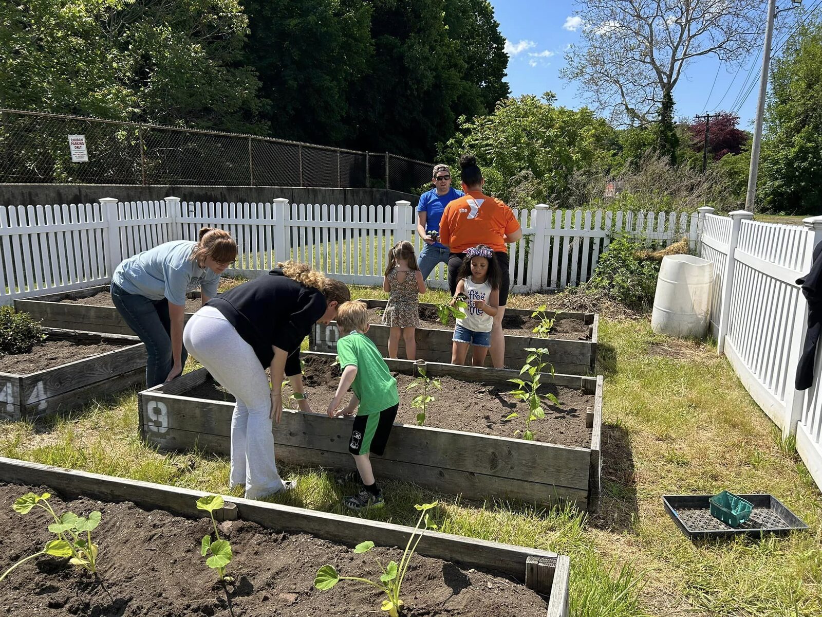 Children tending raised beds in the community garden
