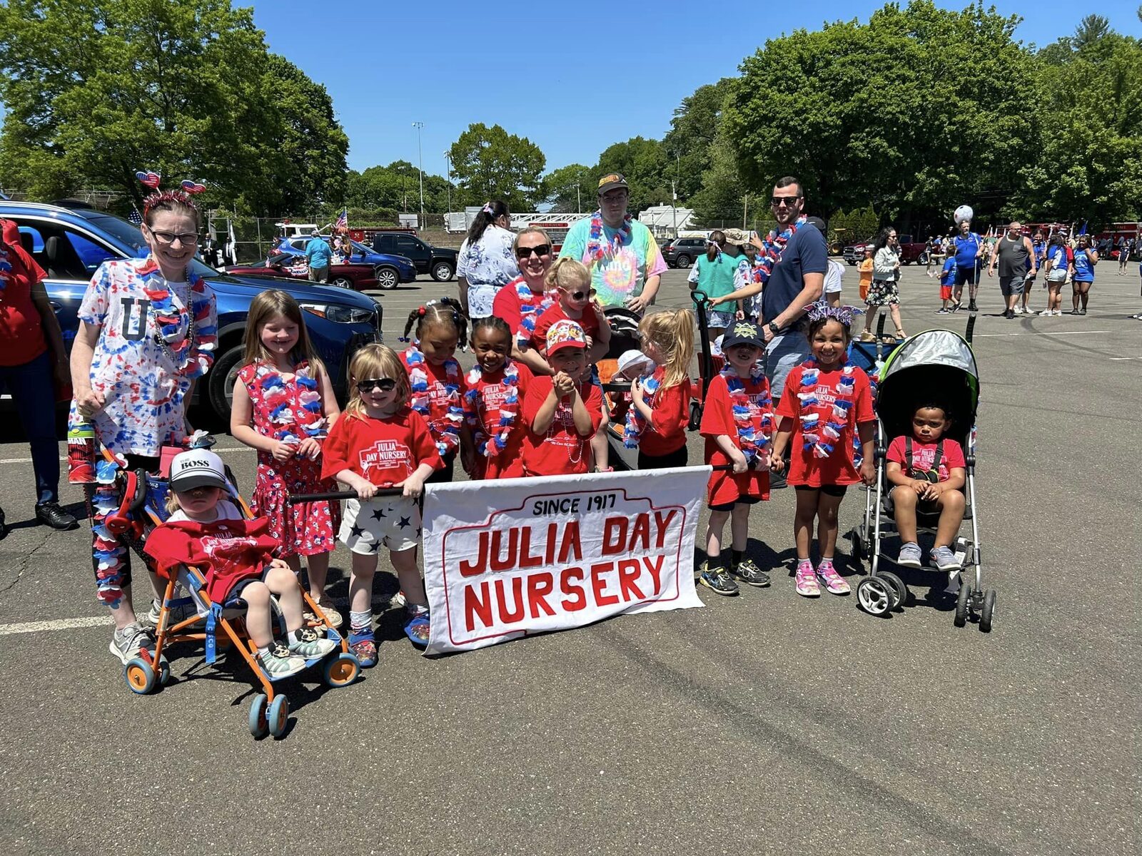 Julia Day Nursery children marching in the Ansonia Memorial Day Parade behind a banner reading Since 1917