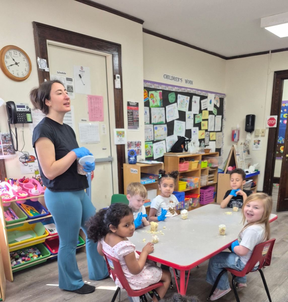 Children around a classroom table during a cooking activity with Munch