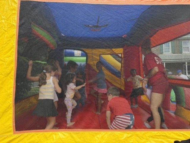 Children jumping inside a bounce house at the Summer Bash